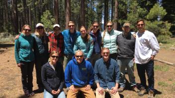 Group of thirteen people in a forest, smiling and wearing casual outdoor clothing in Field Crew Training. Year 2017.